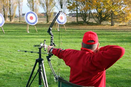 Peter Hammond shooting for St. Dunstans from a chair and using a tactile sight to aim.