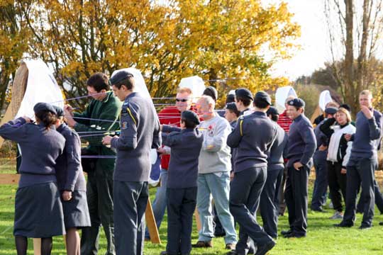 The cadets and helpers go to the targets to score.